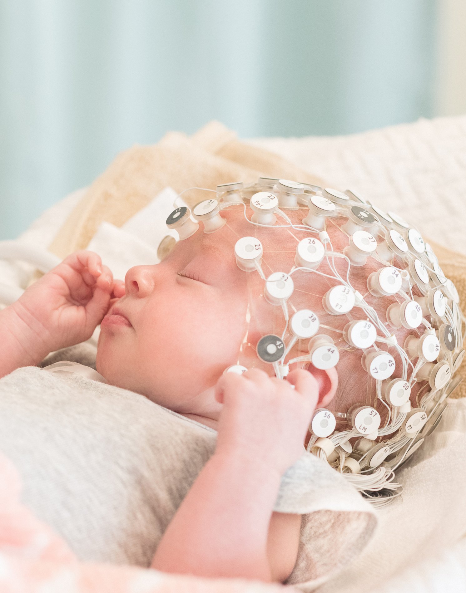 Infant wearing a Geodesic Sensor Net for EEG recording